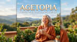 Smiling older woman holding a cup of tea on a terrace with plants and mountains